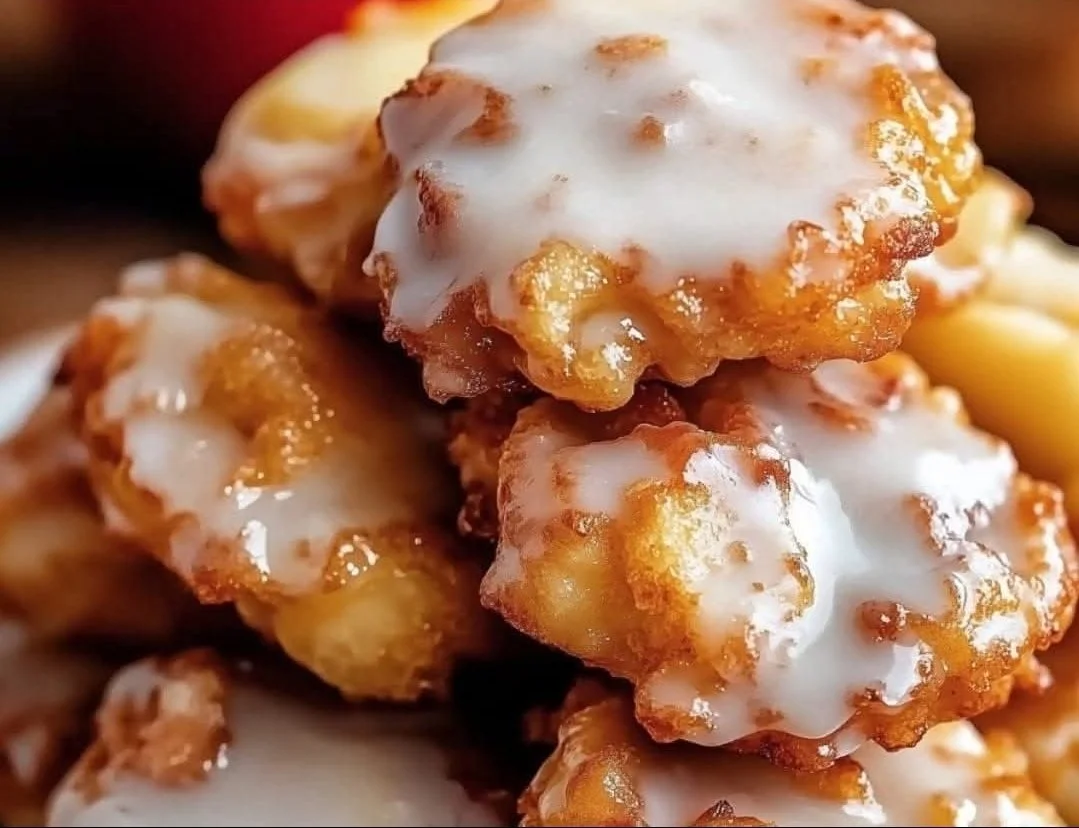 Baked Apple Fritters Delicious baked apple fritters dusted with cinnamon sugar on a plate.