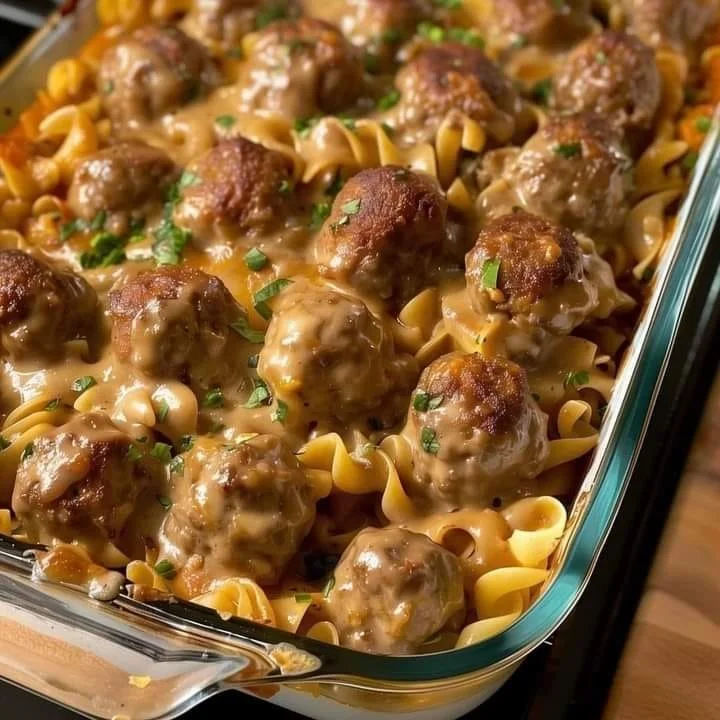 Creamy Meatball Noodle Dish Delicious creamy meatball noodle dish topped with herbs.