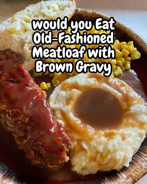 Old-fashioned meatloaf topped with brown gravy on a serving platter.